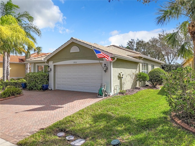 view of front of house featuring a garage and a front lawn