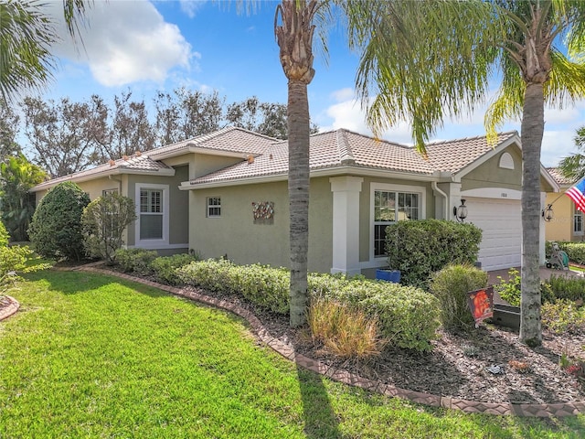 view of front of property with a front lawn and a garage