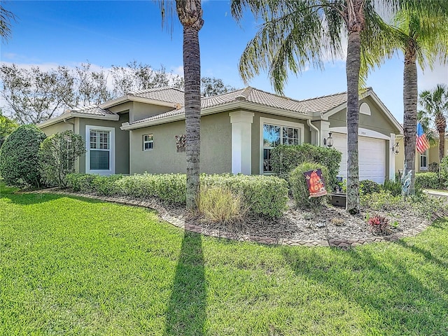 view of front of house featuring a front yard and a garage