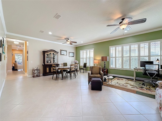 living room with crown molding, light tile patterned flooring, a textured ceiling, and ceiling fan