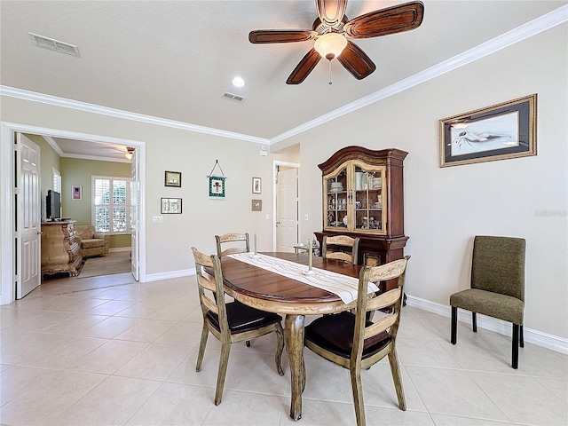 tiled dining area with crown molding, a textured ceiling, and ceiling fan