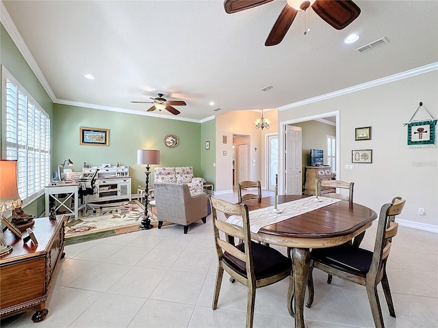 tiled dining area with ornamental molding and ceiling fan with notable chandelier