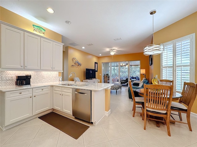 15810 Cobble Mill Dr, Wimauma, FL 33598 - kitchen with dishwasher, a peninsula, light tile patterned flooring, a sink, and light countertops