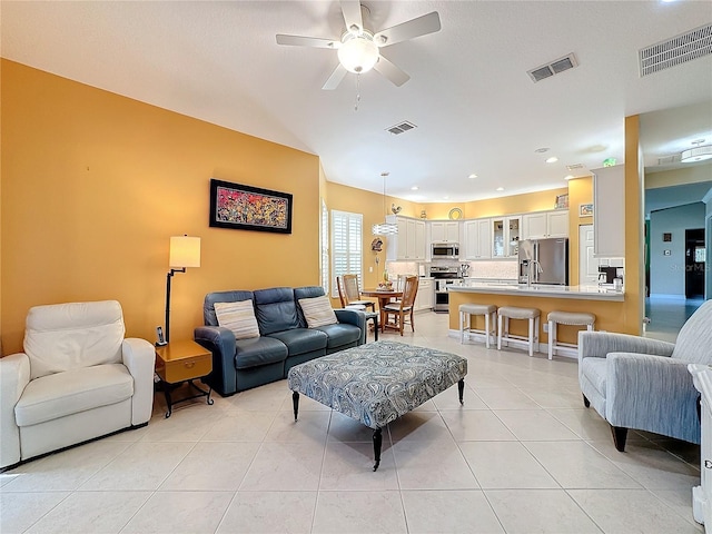 living room with light tile patterned flooring and ceiling fan