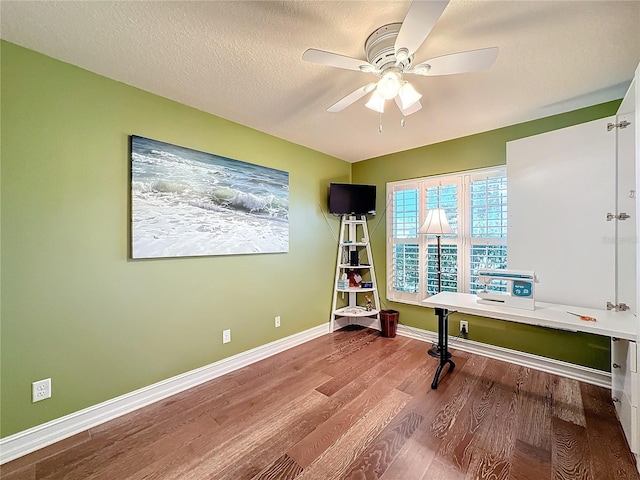 unfurnished office with hardwood / wood-style floors, a textured ceiling, and ceiling fan