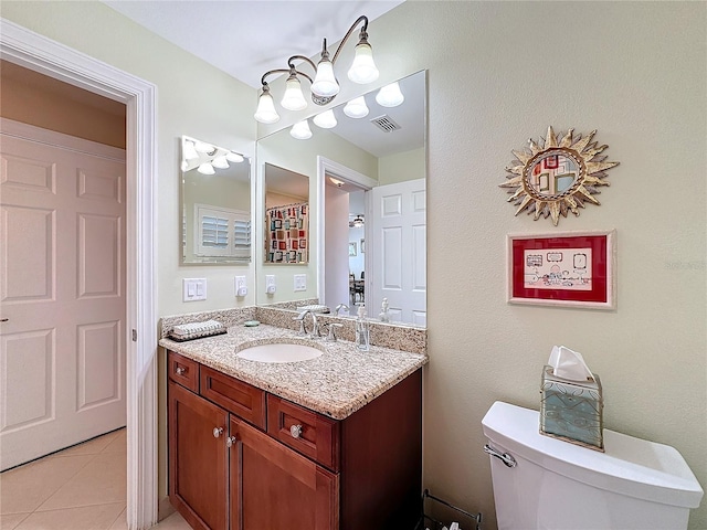 bathroom featuring vanity, toilet, and tile patterned flooring