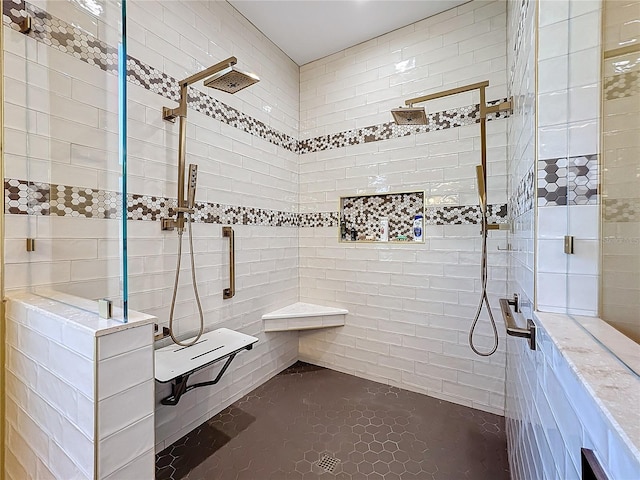 bathroom with tile walls, tile patterned floors, and a tile shower