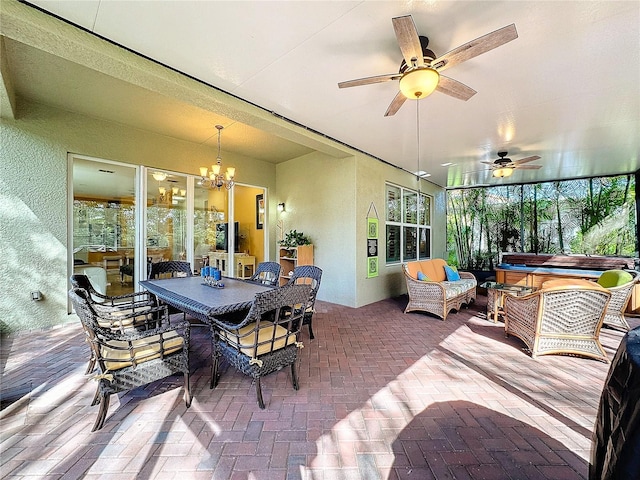 sunroom / solarium with ceiling fan with notable chandelier