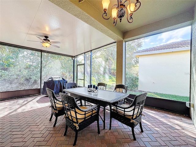 sunroom / solarium featuring a healthy amount of sunlight and ceiling fan