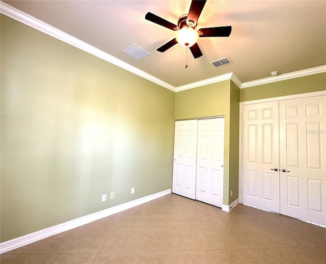 15810 Cobble Mill Dr, Wimauma, FL 33598 - unfurnished bedroom with light tile patterned floors, ornamental molding, baseboards, ceiling fan, and a textured ceiling