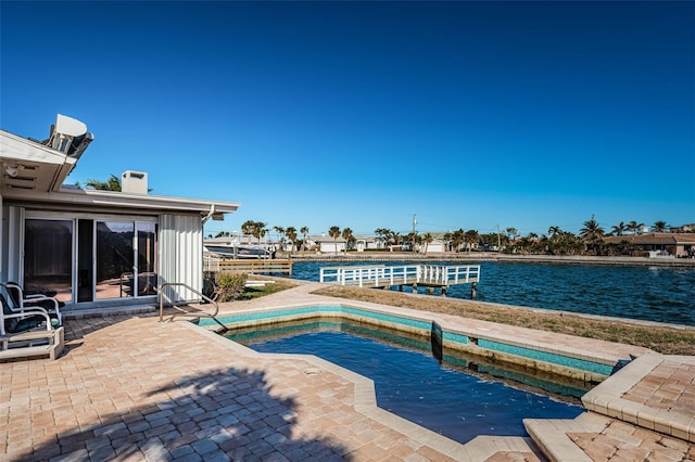 view of swimming pool with a water view and a patio