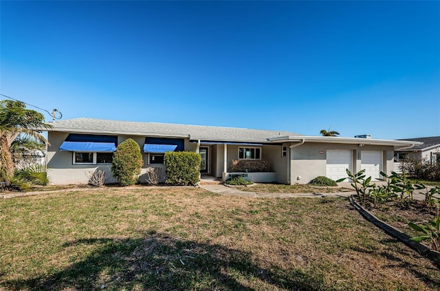 ranch-style home featuring a front yard and a garage