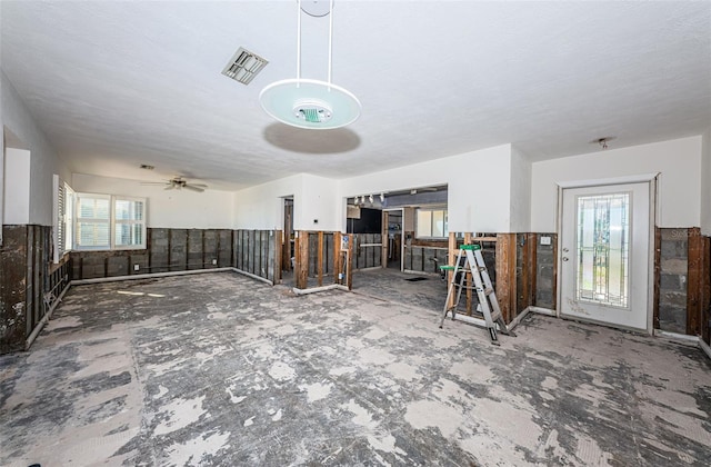 misc room featuring a wealth of natural light, ceiling fan, and a textured ceiling