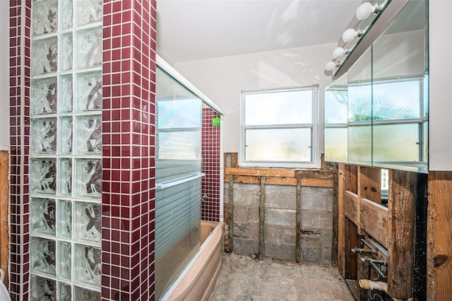 bathroom featuring a shower and concrete floors