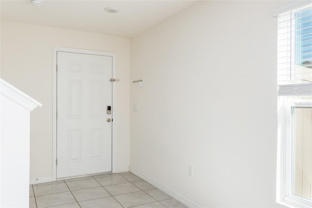 doorway to outside with light tile patterned floors