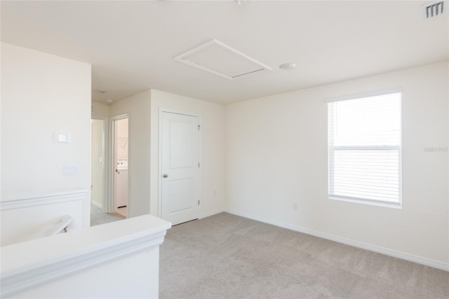 carpeted empty room featuring washer / clothes dryer