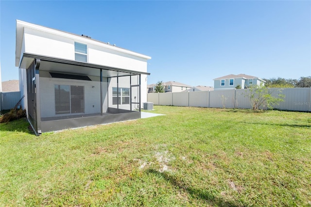 rear view of house featuring a yard, a patio, and central AC unit