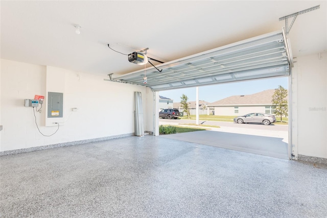 garage with electric panel and a garage door opener