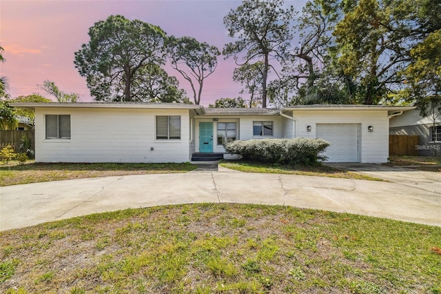 single story home with a yard and a garage