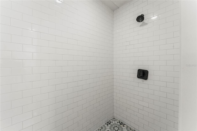 bathroom with tiled shower