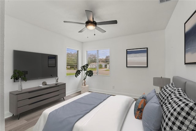 bedroom with light hardwood / wood-style floors and ceiling fan