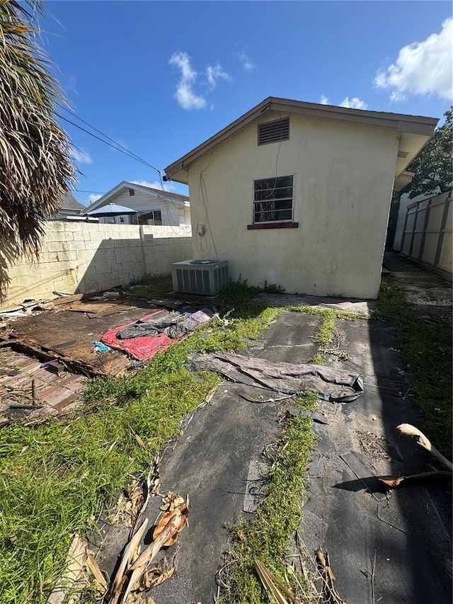 back of house featuring central AC