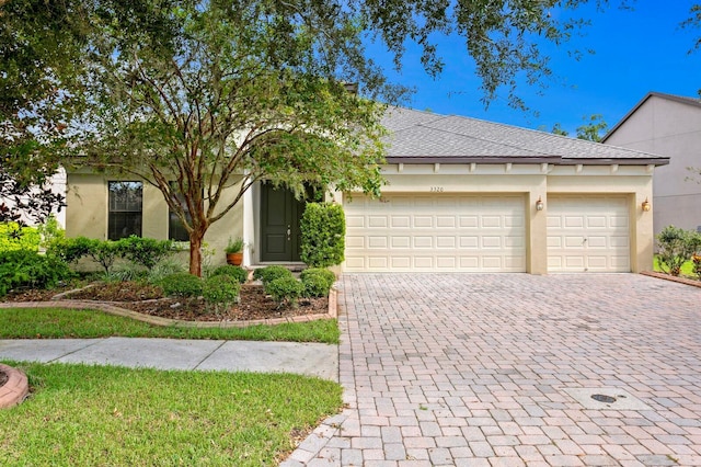 3320 Majestic View Dr, Lutz, FL 33558 - view of front of property with decorative driveway, stucco siding, and a garage