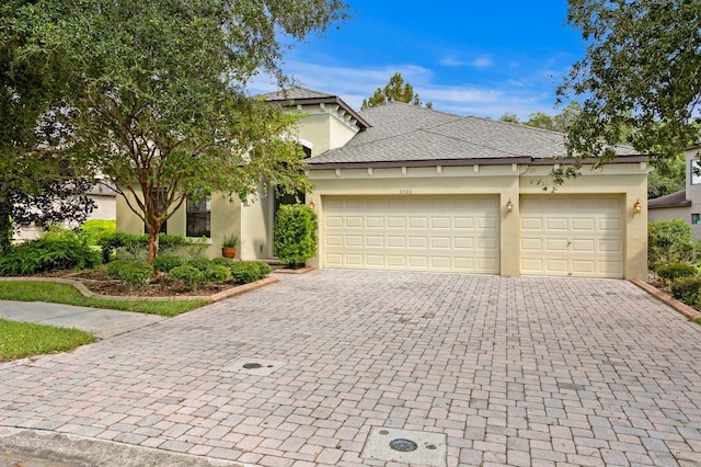 3320 Majestic View Dr, Lutz, FL 33558 - view of front facade featuring decorative driveway, stucco siding, an attached garage, and roof with shingles