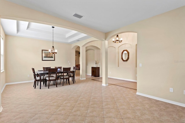 3320 Majestic View Dr, Lutz, FL 33558 - dining area with a chandelier, a raised ceiling, and light tile patterned floors