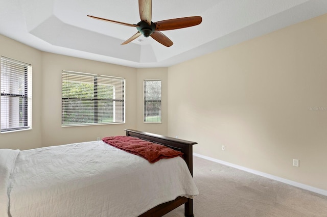 3320 Majestic View Dr, Lutz, FL 33558 - bedroom with a raised ceiling, carpet, baseboards, and a ceiling fan