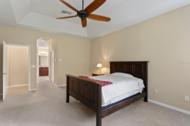 3320 Majestic View Dr, Lutz, FL 33558 - bedroom featuring light carpet, arched walkways, a raised ceiling, baseboards, and ceiling fan