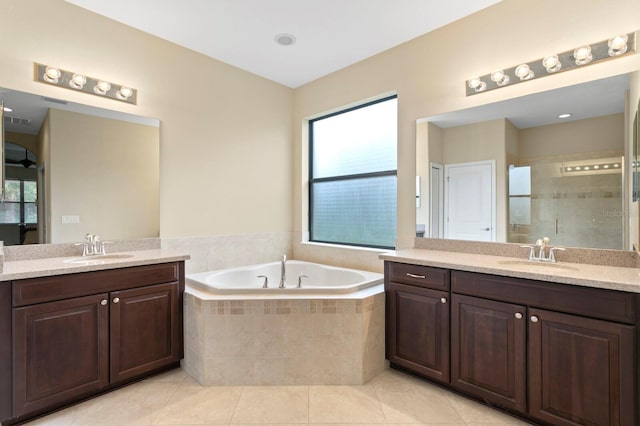 3320 Majestic View Dr, Lutz, FL 33558 - bathroom with two vanities, a stall shower, a garden tub, and tile patterned flooring