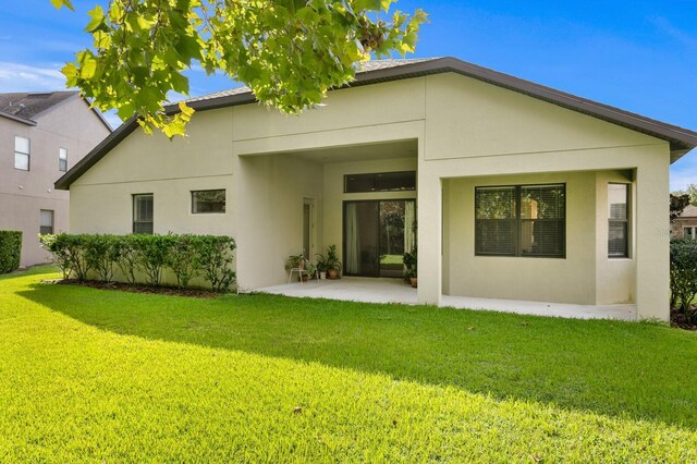 3320 Majestic View Dr, Lutz, FL 33558 - rear view of property with stucco siding, a yard, and a patio area