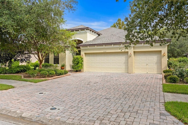 3320 Majestic View Dr, Lutz, FL 33558 - mediterranean / spanish-style house featuring decorative driveway, stucco siding, and a garage
