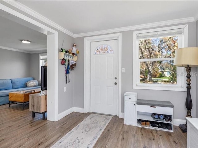 foyer featuring light hardwood / wood-style flooring and ornamental molding