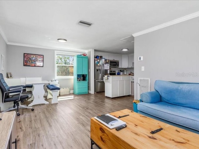 living room featuring ornamental molding and wood-type flooring