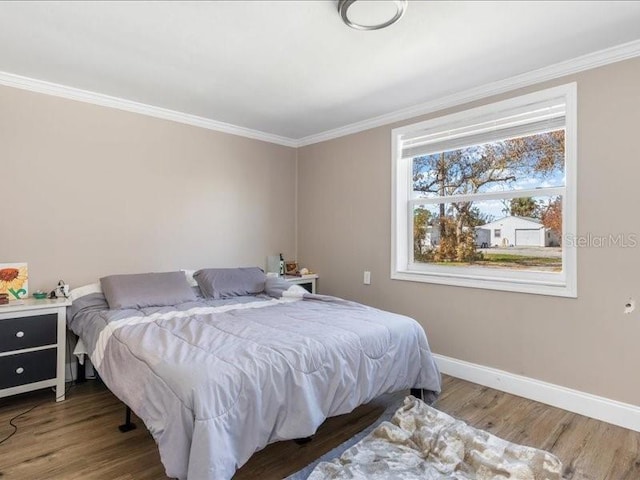 bedroom with crown molding and wood-type flooring