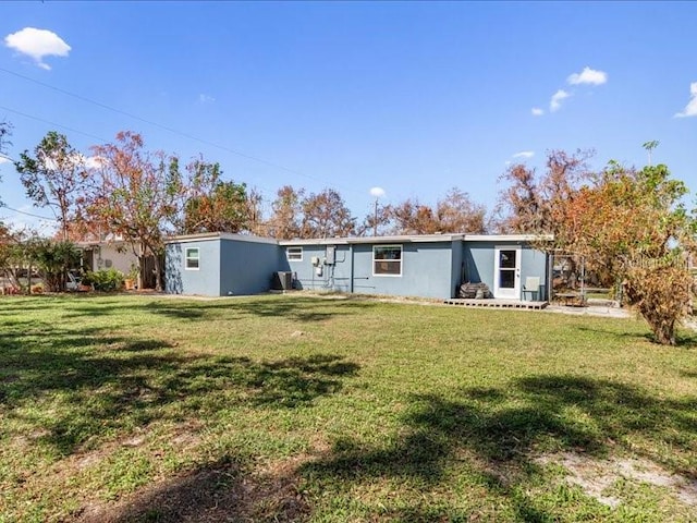 rear view of property featuring a yard