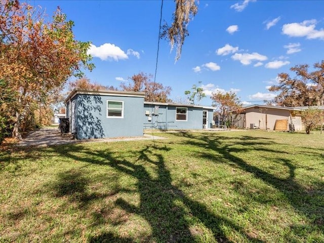 back of property featuring a yard