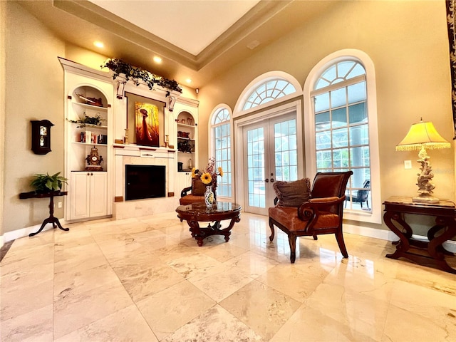 living area with built in shelves and french doors