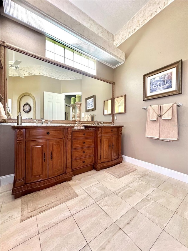 bathroom with ceiling fan and vanity