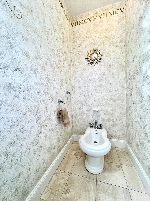 bathroom featuring tile patterned flooring and a bidet