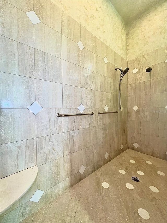 bathroom with a tile shower