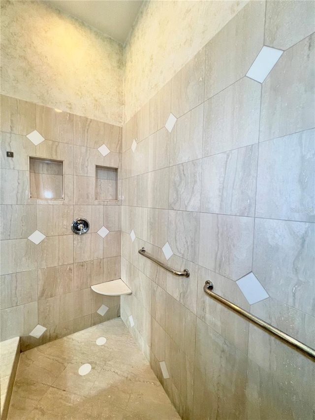 bathroom with tiled shower