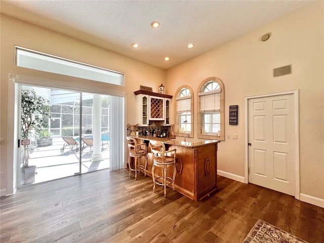 bar featuring dark hardwood / wood-style flooring