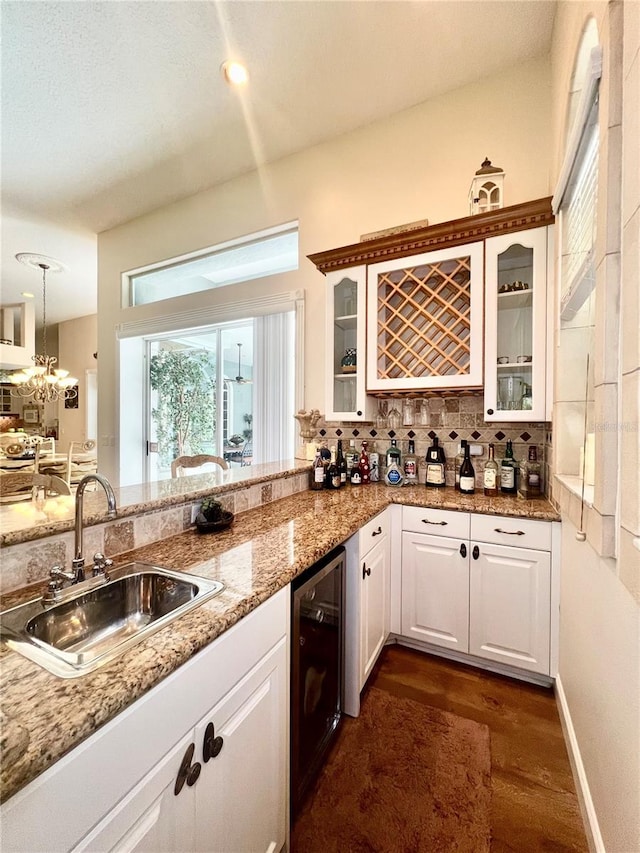 kitchen with white cabinetry, sink, wine cooler, dark hardwood / wood-style floors, and decorative light fixtures