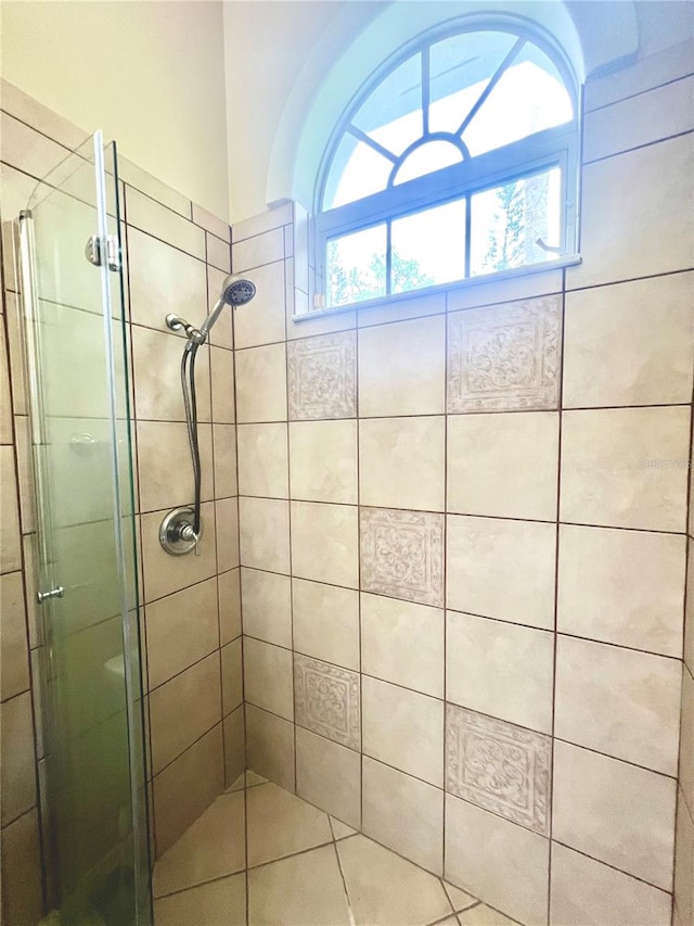 bathroom featuring a shower with shower door