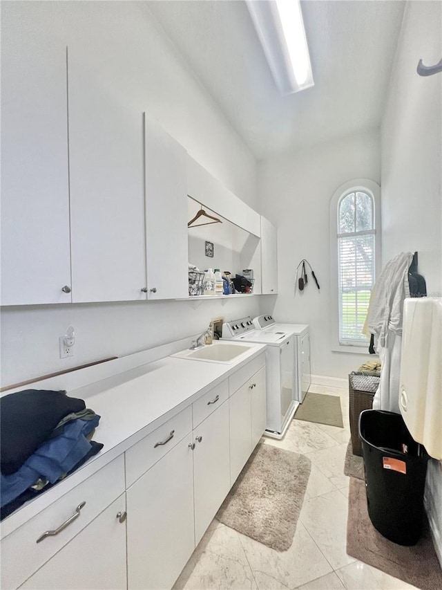 clothes washing area featuring cabinets, light tile patterned floors, separate washer and dryer, and sink