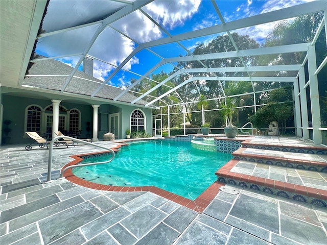 view of swimming pool featuring ceiling fan, a lanai, a patio, and an in ground hot tub