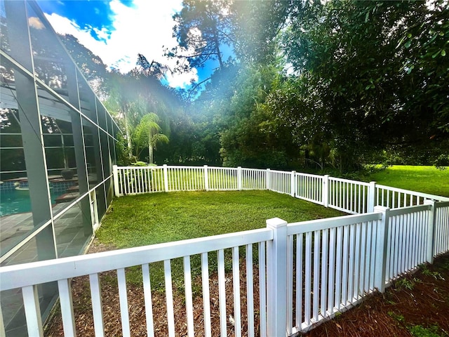 view of yard featuring glass enclosure